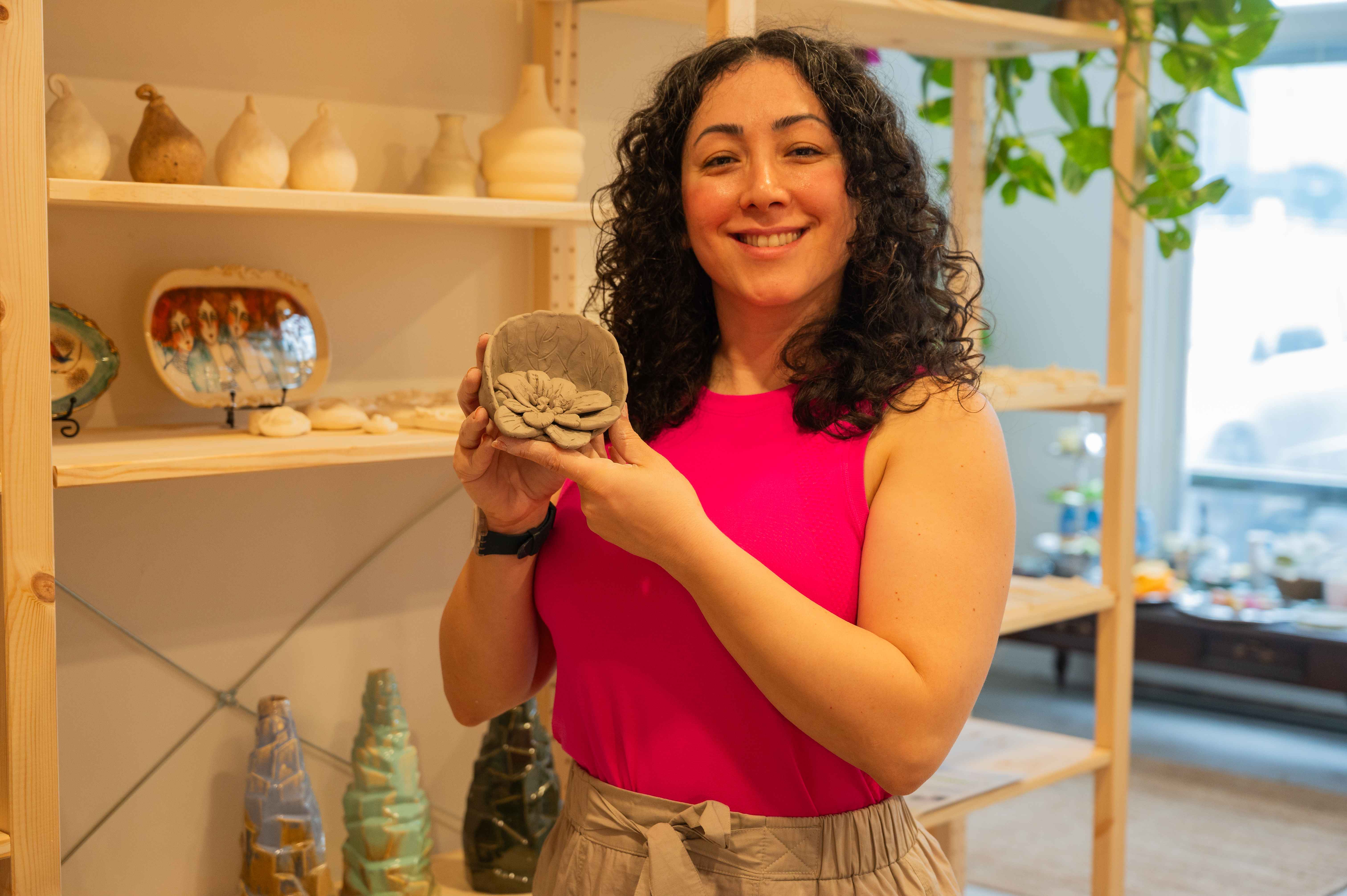 Student with Pottery Creation