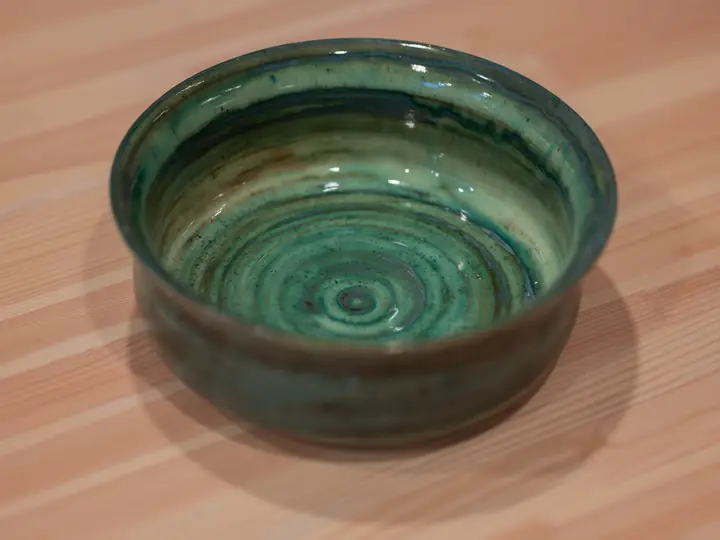 A deep green bowl a student threw on the wheel